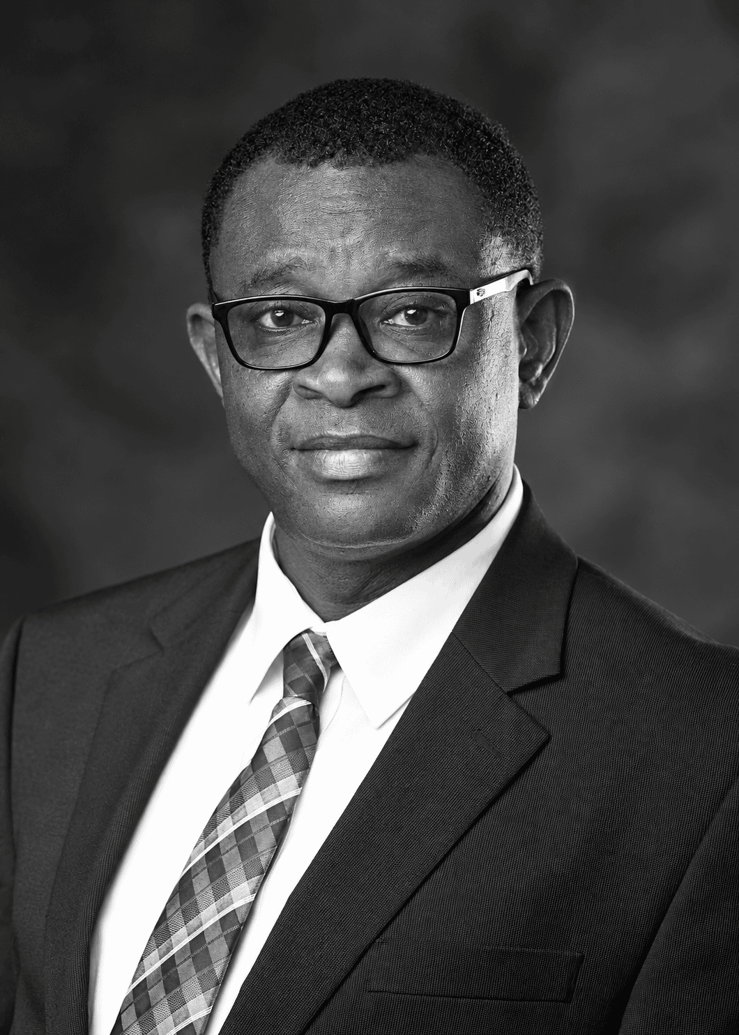 Black-and-white portrait of Dr Julius A. Nukpezah, Governance and Public Finance Advisor to the Kente Registry