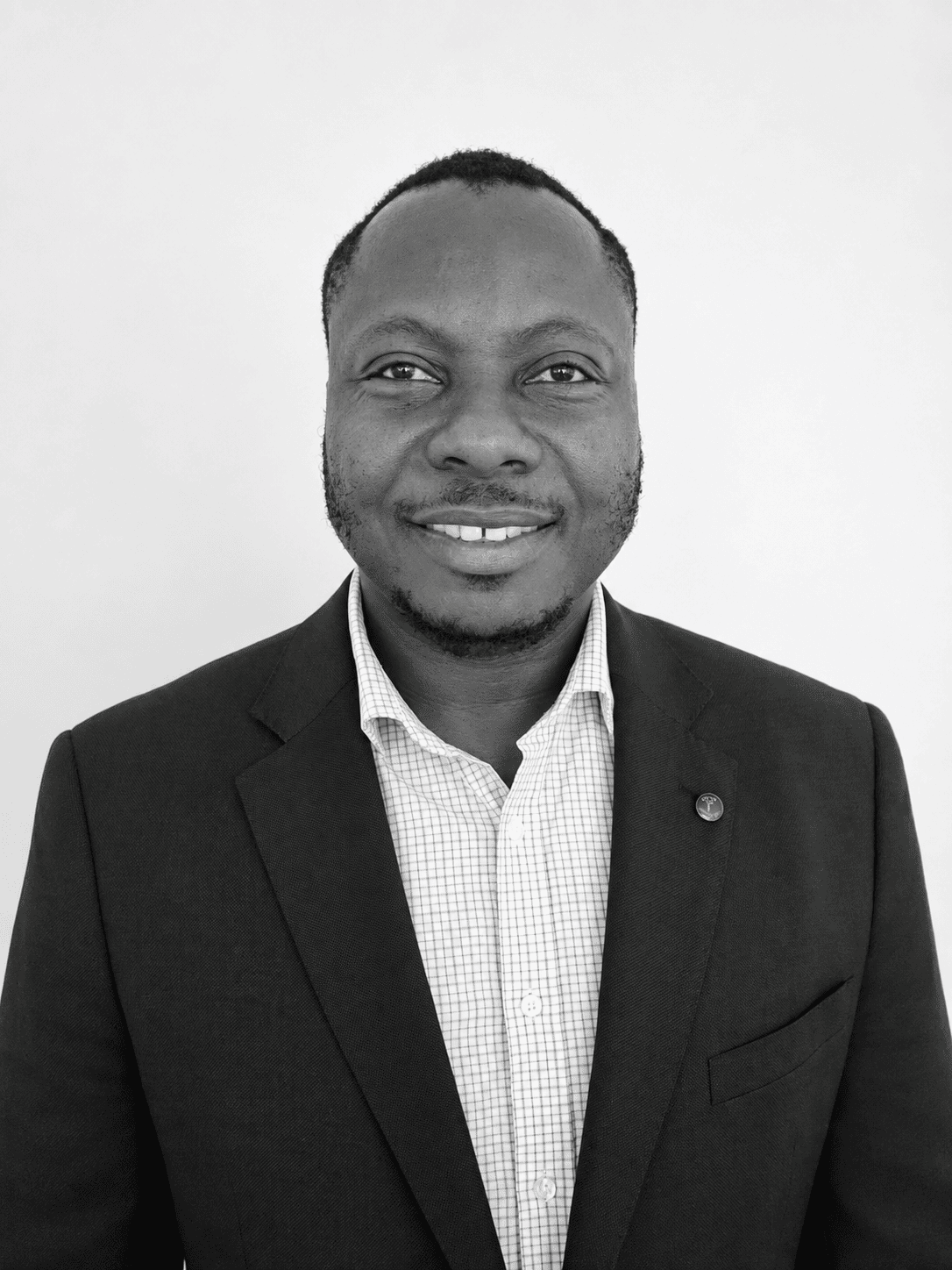 Black-and-white portrait of Samuel Anum Adjei, Director of Kente Registry Limited